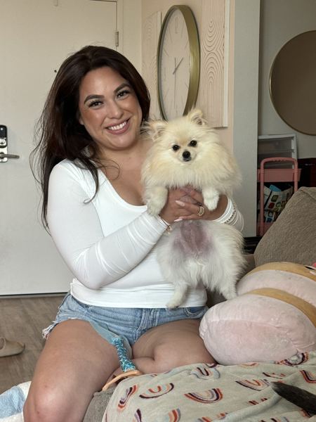 Candace holding a fluffy cream Pomeranian
